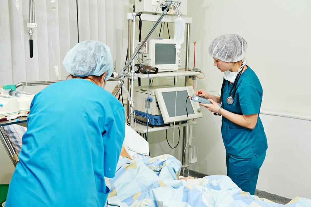 surgeons in uniform in operation or reanimation room at cardiac surgery clinic